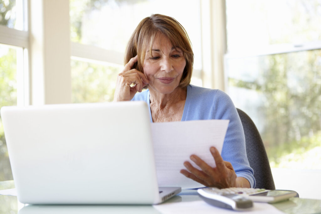 senior hispanic woman working in home office